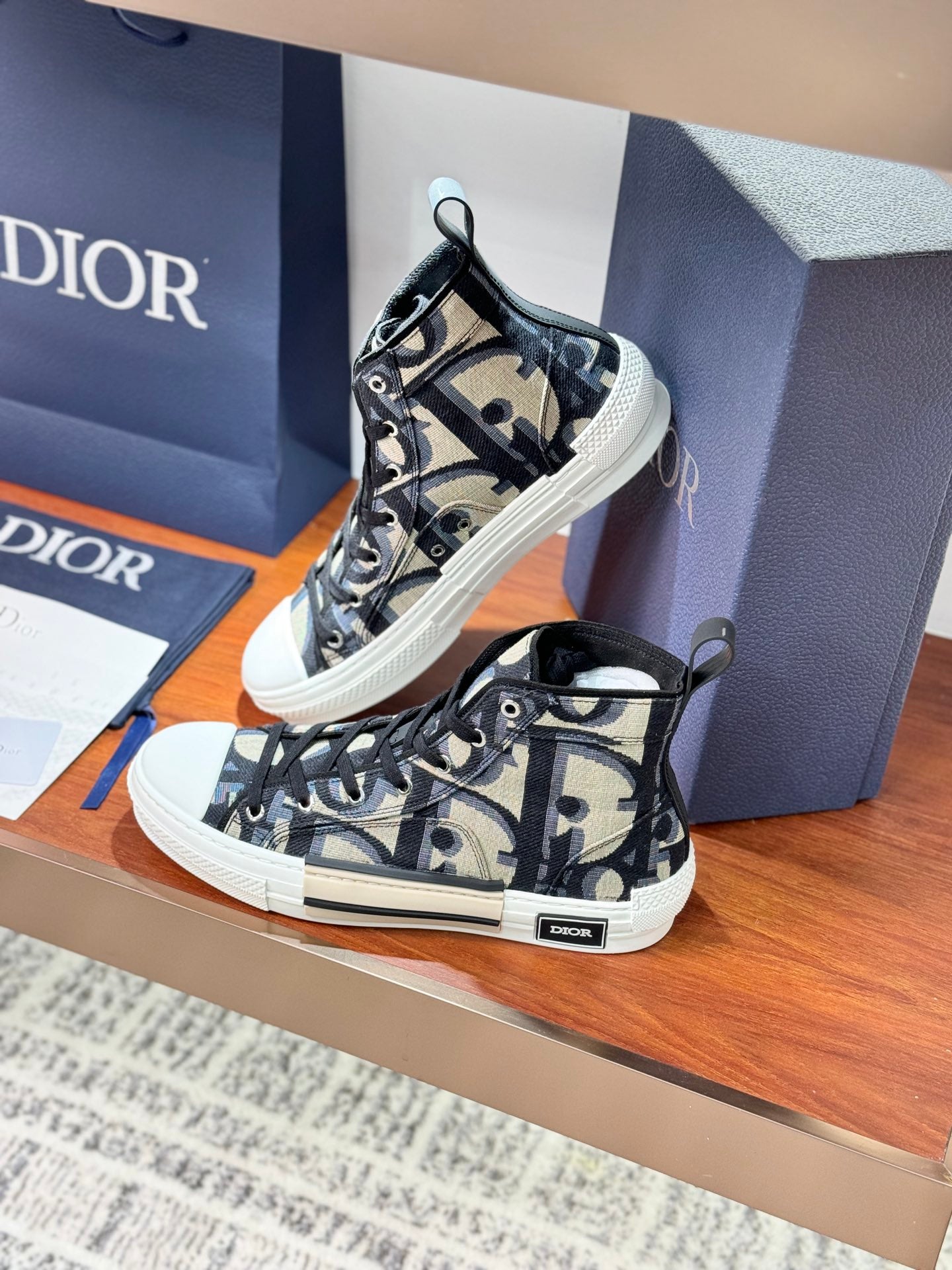 Dior ladies high-top sneakers, close side angle, black-and-beige patterned canvas