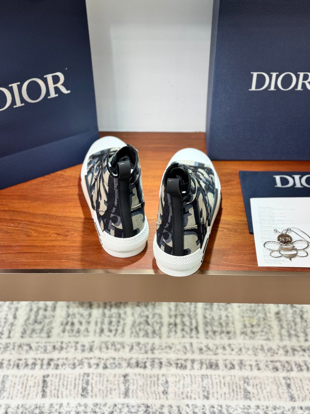 Dior ladies high-top sneakers, back view with heel pull tabs and monogram canvas