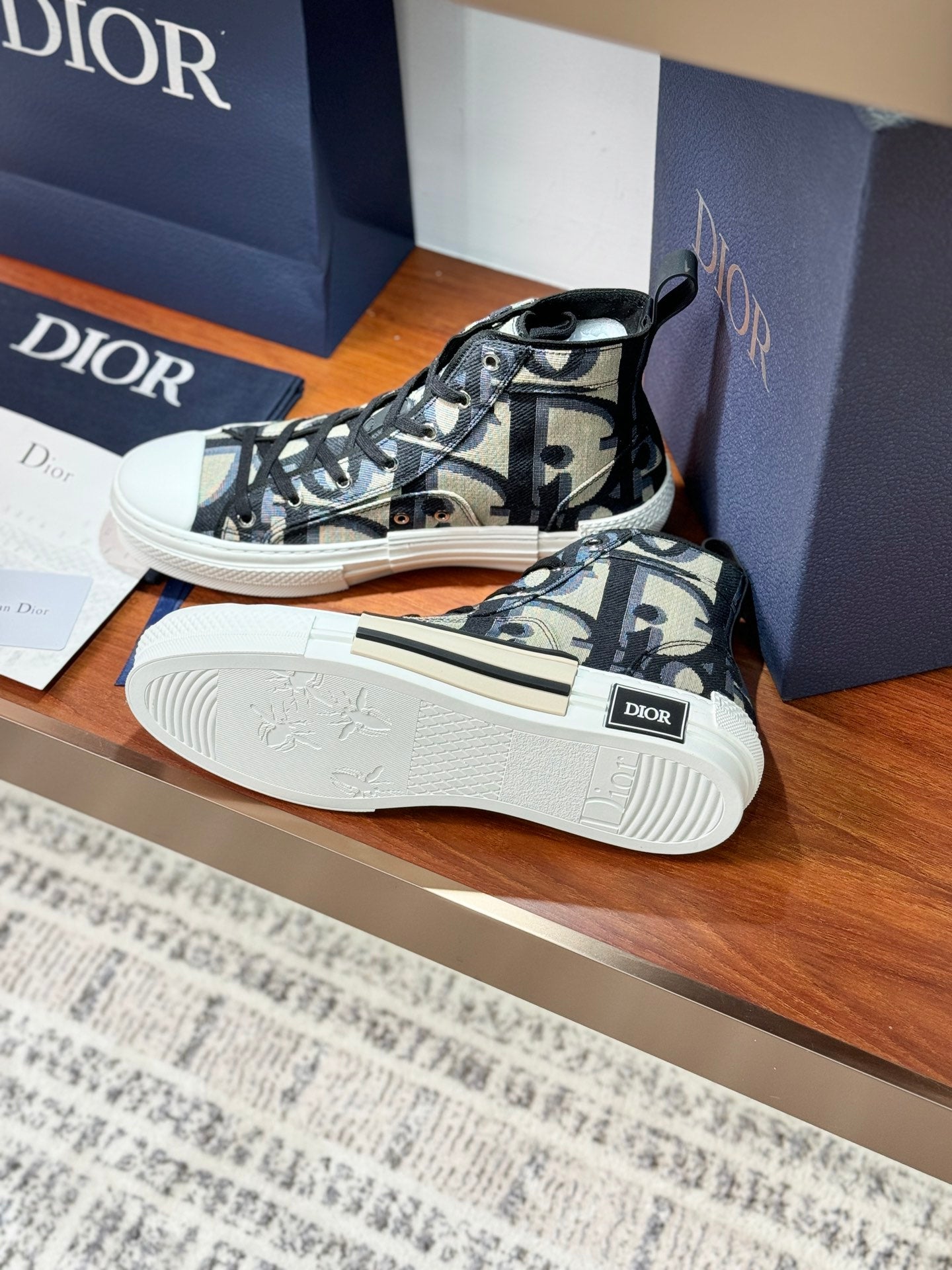 Dior ladies high-top sneakers, visible outsole tread, black-and-beige monogram canvas