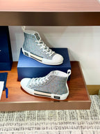 Women's gray-blue patterned high-top sneakers with white laces on display shelf