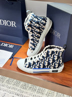 Dior high-top sneakers, close view of blue monogram print and white rubber sole