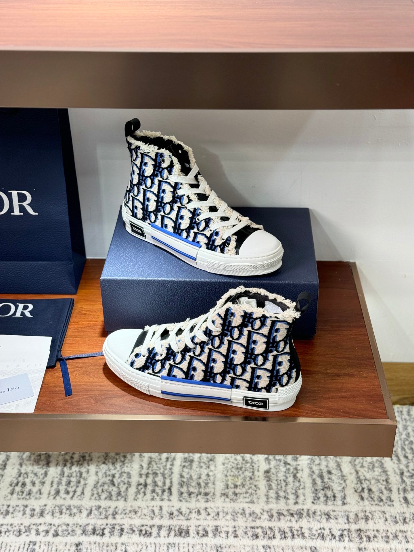 Dior high-top sneaker with blue monogram print, white laces and padded collar