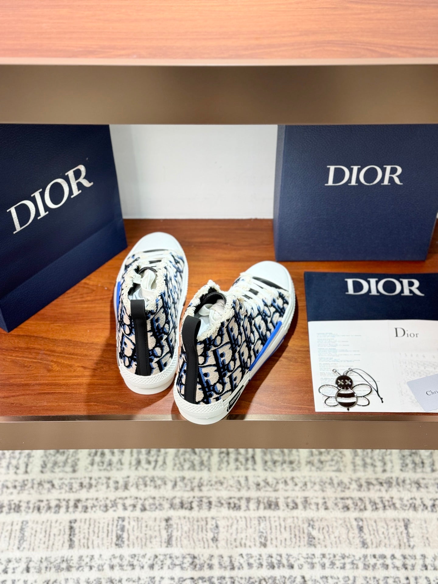 Dior high-top sneakers with blue monogram print and white lace-up, top view