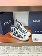 Dior high-top sneakers, side view, blue monogram pattern, white laces and sole