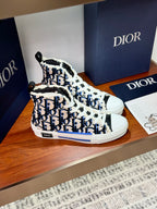 Dior high-top sneakers, angled front view, blue monogram print and white lace-up