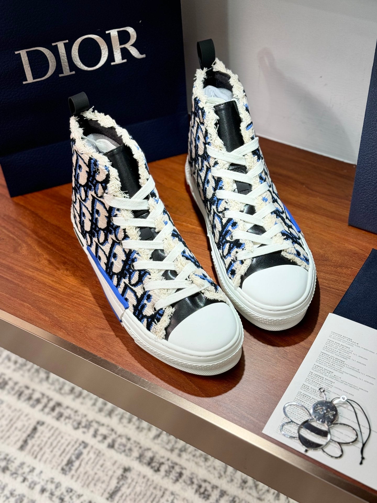Dior high-top sneakers, pair front view, blue monogram print with white laces