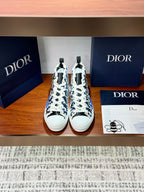 Dior high-top sneakers with blue monogram print, white laces and rubber sole