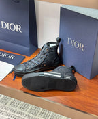 Dior ladies high-top sneakers with dark uppers and visible tread sole on the floor