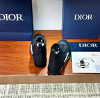 Dior ladies sneakers shown from toe and side: dark patterned high-tops with lace-up closure