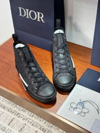 Pair of Dior ladies high-top sneakers in dark leather with lace-up design and white sole stripe