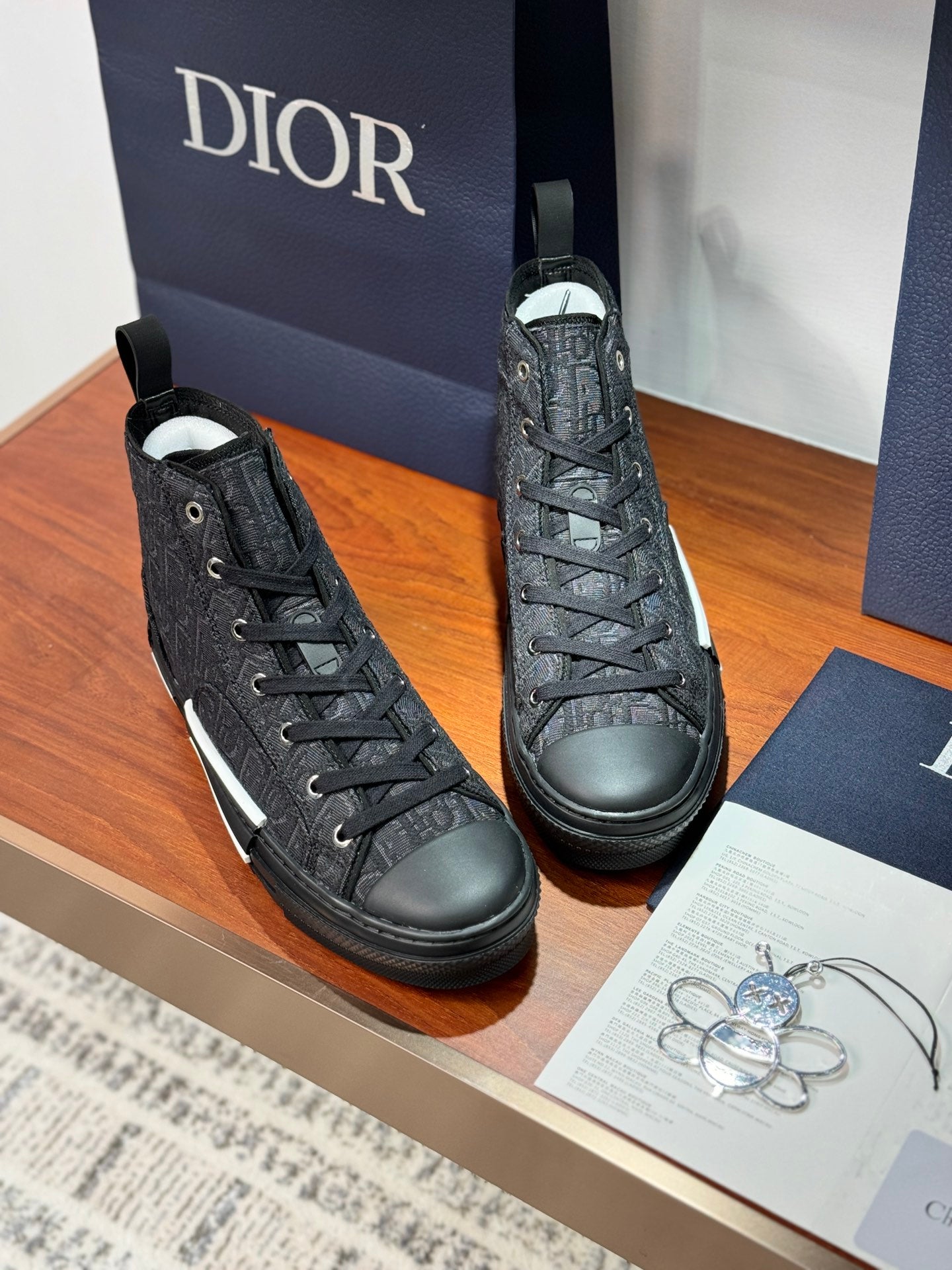 Pair of Dior ladies high-top sneakers in dark leather with lace-up design and white sole stripe
