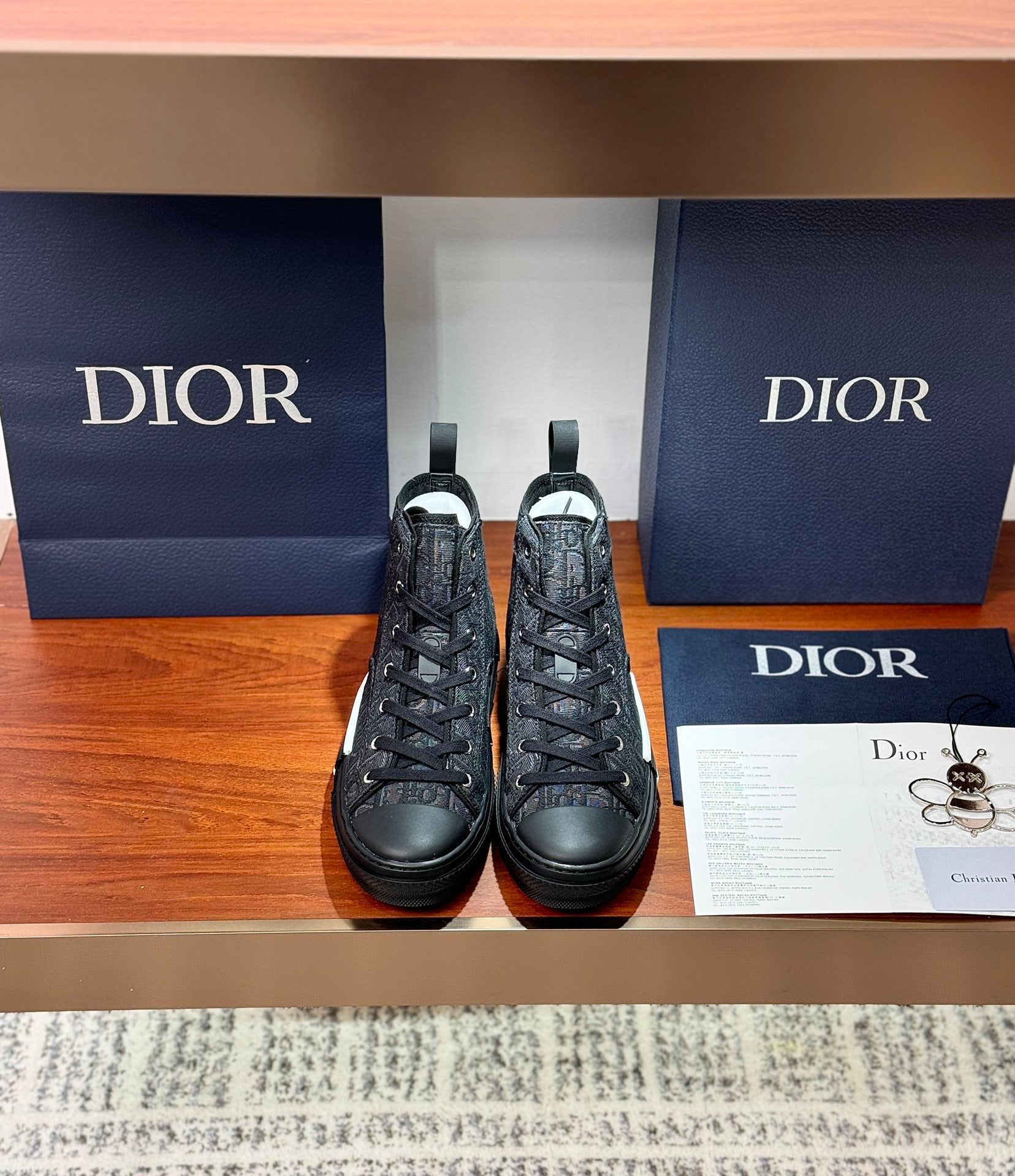 Dior ladies high-top sneakers in dark leather with lace-up front and black rubber sole
