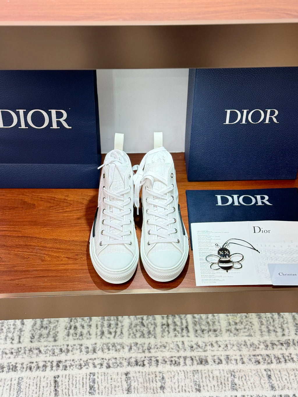 Dior white high-top lace-up sneakers with textured logo detail and rubber sole