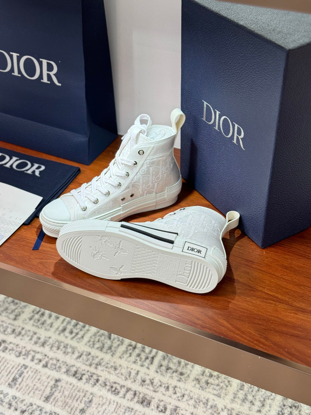 Dior white high-top lace-up sneakers with logo pattern on side and outsole detail