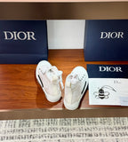 Dior white textured high-top lace-up sneakers with black stripe accents on sole
