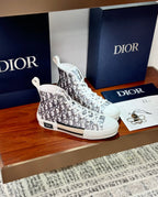 Two white Dior monogram high-top sneakers at an angled view, lace-up style