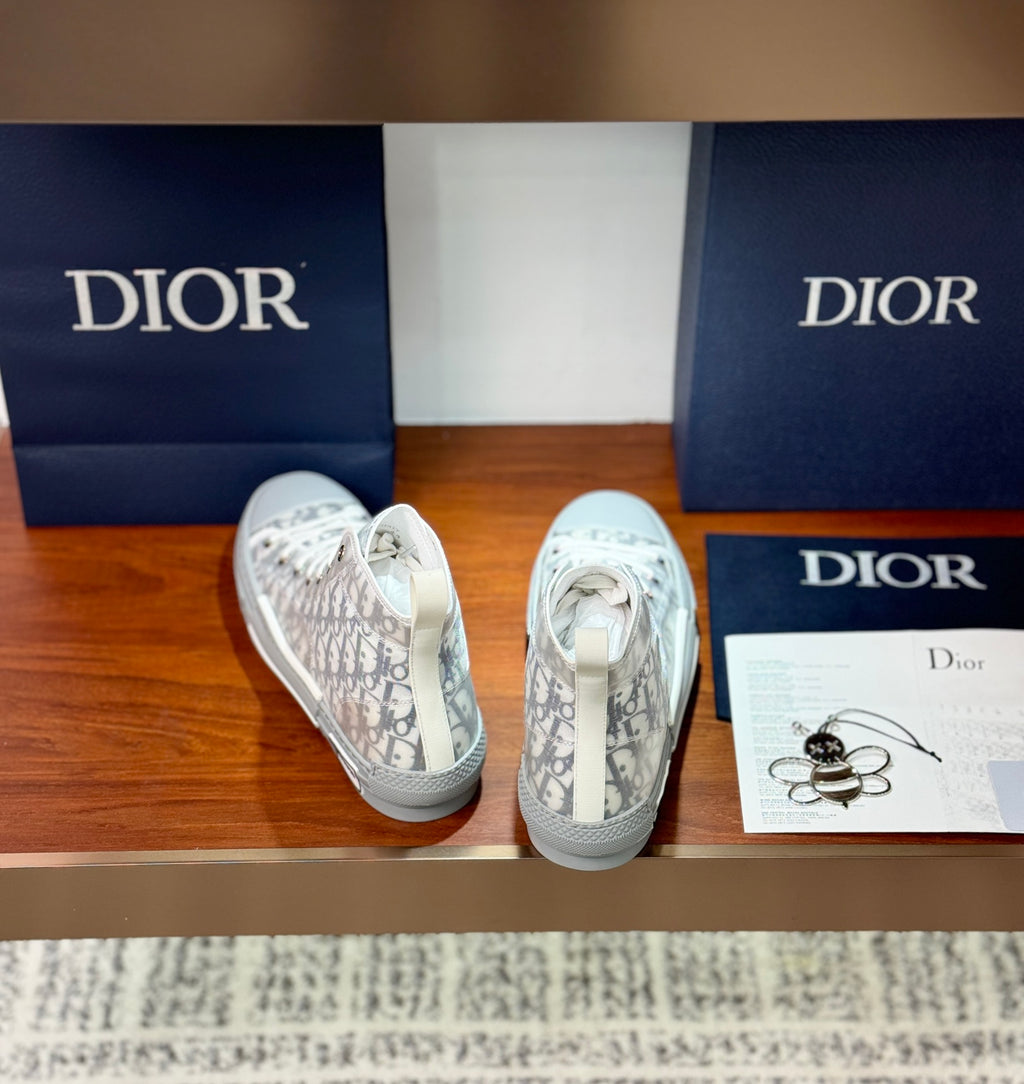 White Dior monogram sneakers with lace-up front and visible interior lining.