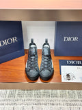 Dior ladies high-top sneakers in dark gray leather with lace-up front and rubber sole.
