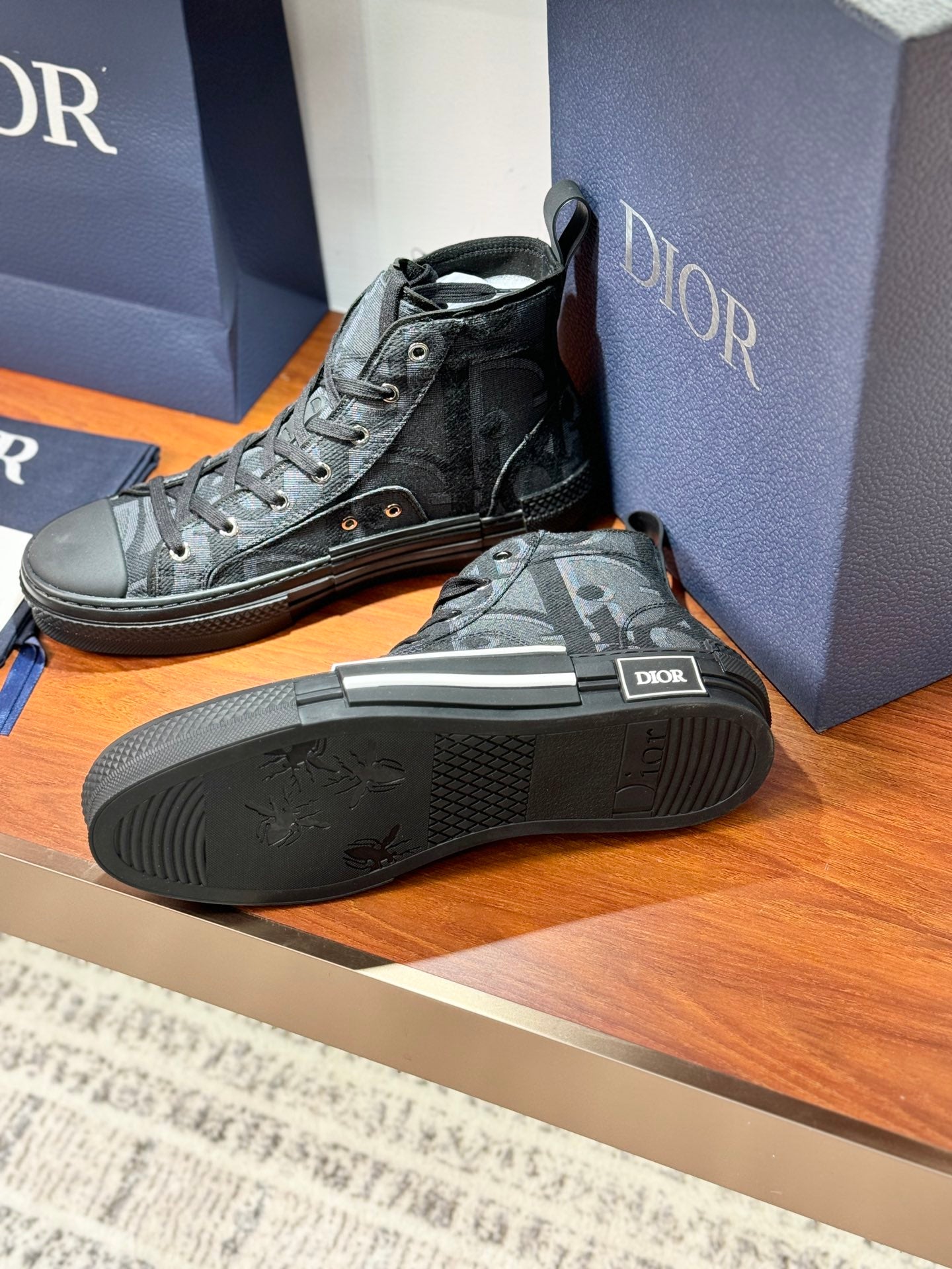 Dior ladies sneakers with textured sole, dark gray lace-up uppers with monogram print.