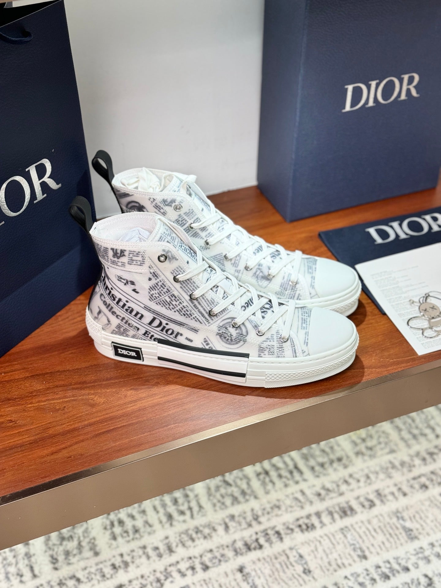 Pair of white Dior ladies high-top sneakers with lace-up and patterned uppers