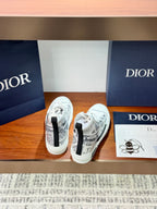 White Dior ladies sneakers with lace-up, heel view and printed upper details
