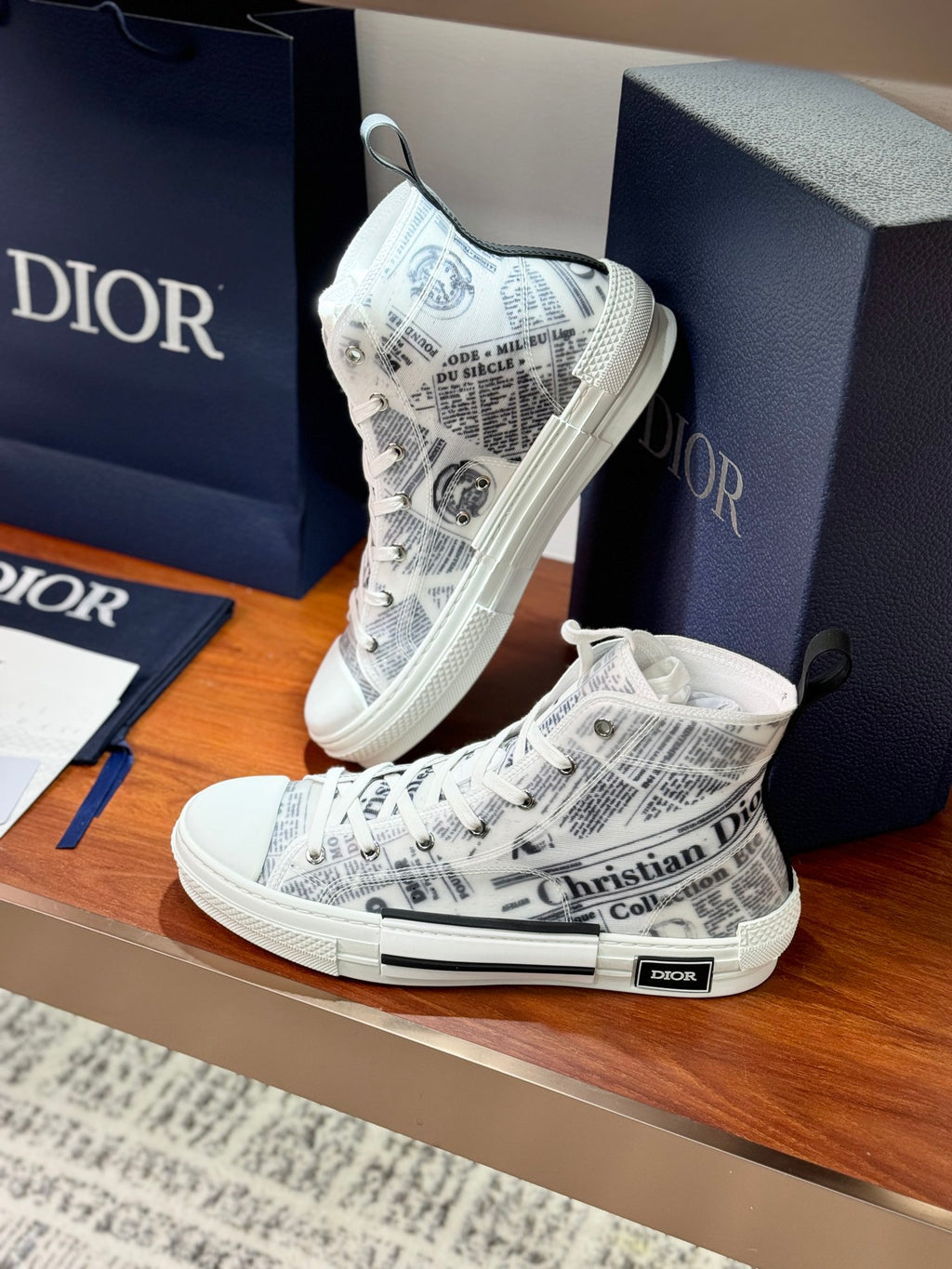 White Dior ladies high-top sneakers with lace-up, side angle showing heel