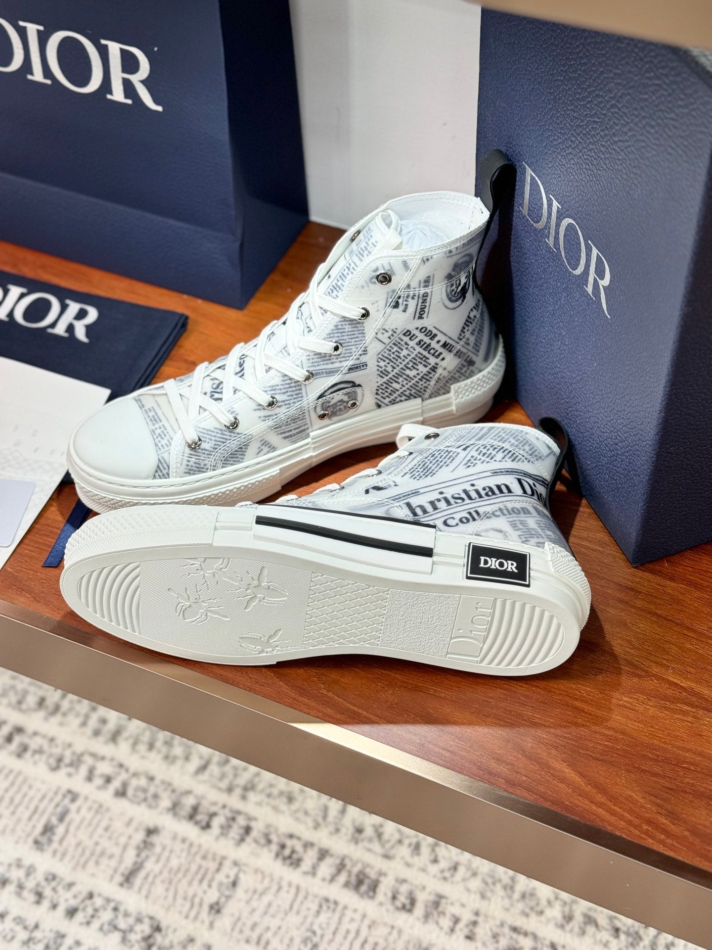 White Dior ladies sneakers with lace-up and patterned sole, front corner view