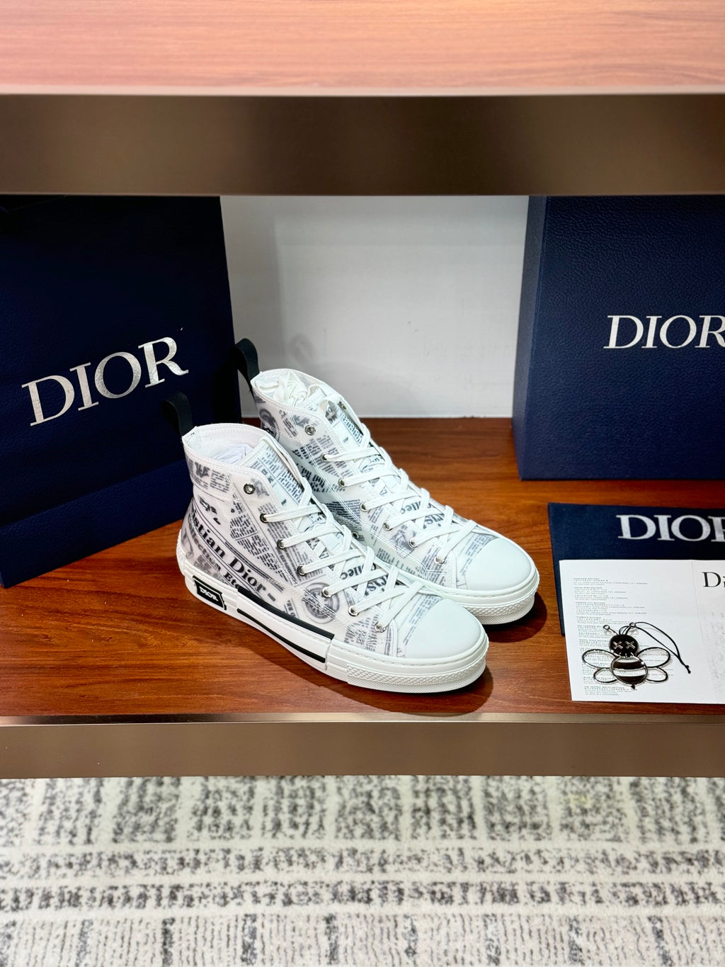 White Dior ladies sneakers, side view with lace-up and all-over printed logo pattern