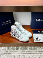 White Dior ladies sneakers, side view with lace-up and all-over printed logo pattern