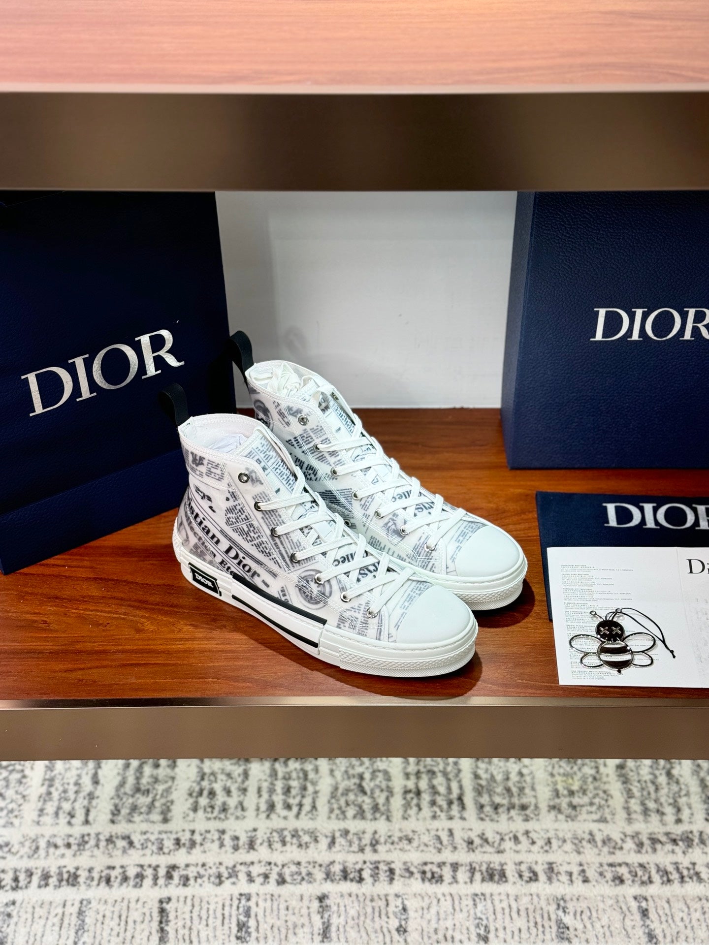 White Dior ladies sneakers, side view with lace-up and all-over printed logo pattern