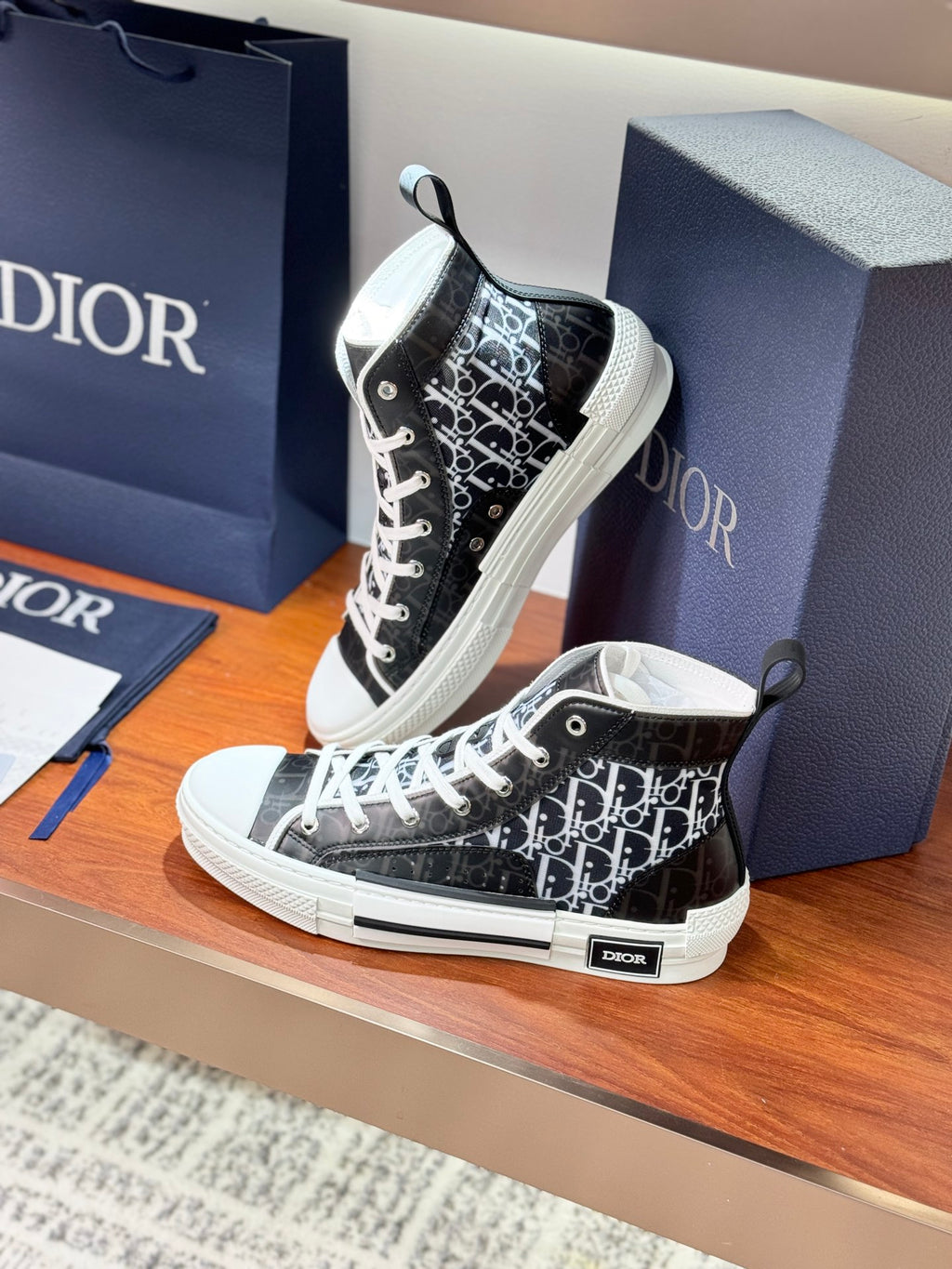 Black monogram high-top sneakers with white laces and Dior patch on heel