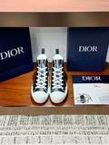 High-top Dior sneakers with black-and-white monogram canvas, white laces, rubber sole