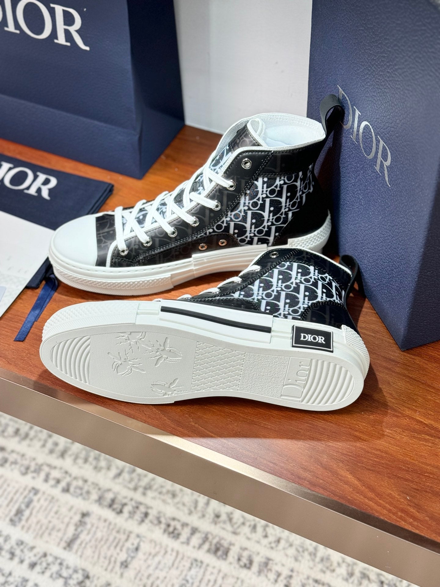 Side view high-top Dior sneakers with black monogram upper and white rubber sole