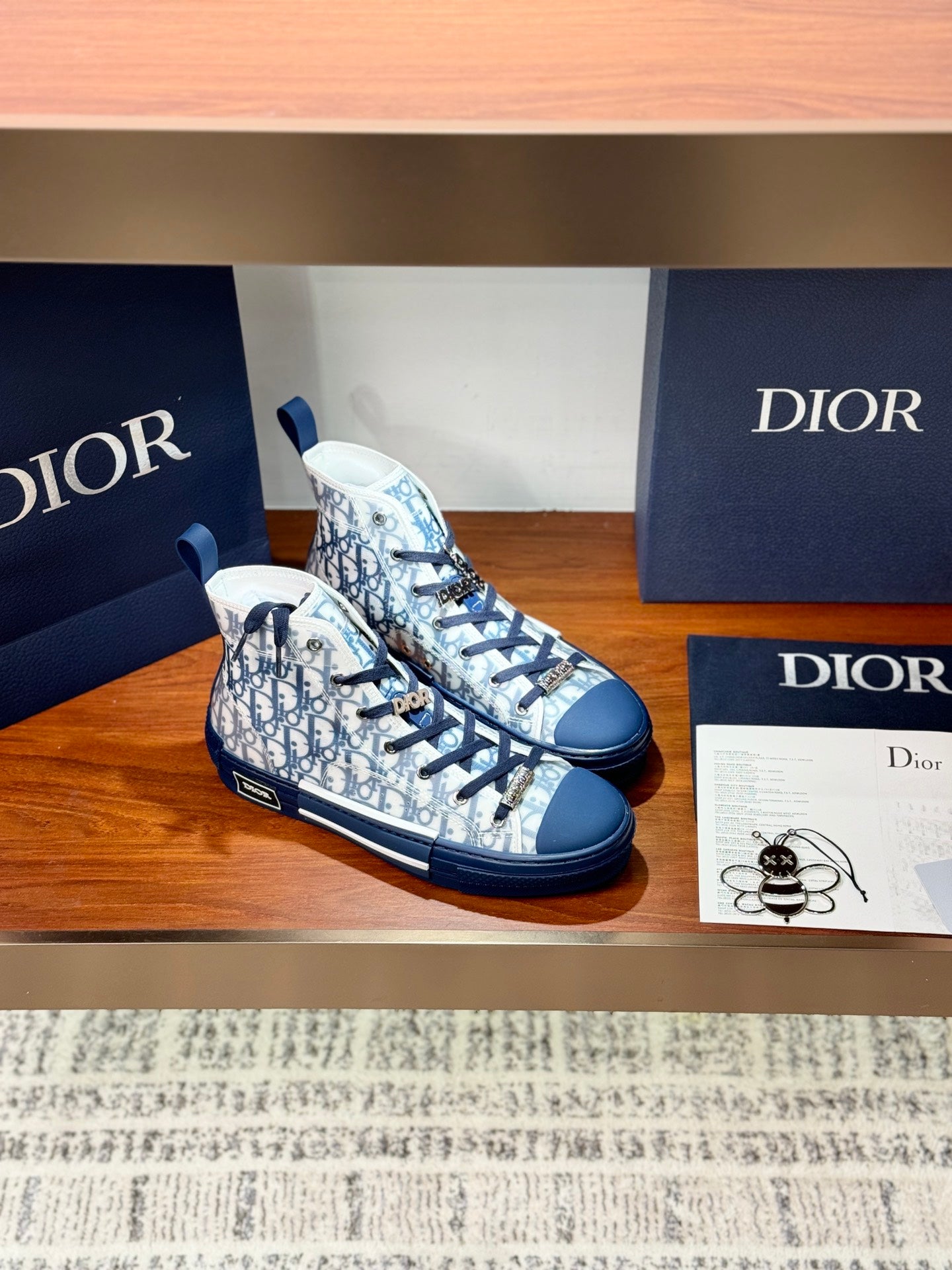 High-top sneakers with blue laces and Dior monogram print, side angle