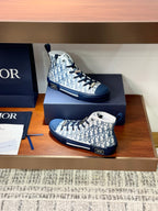 Two high-top sneakers with Dior monogram fabric and blue laces in box