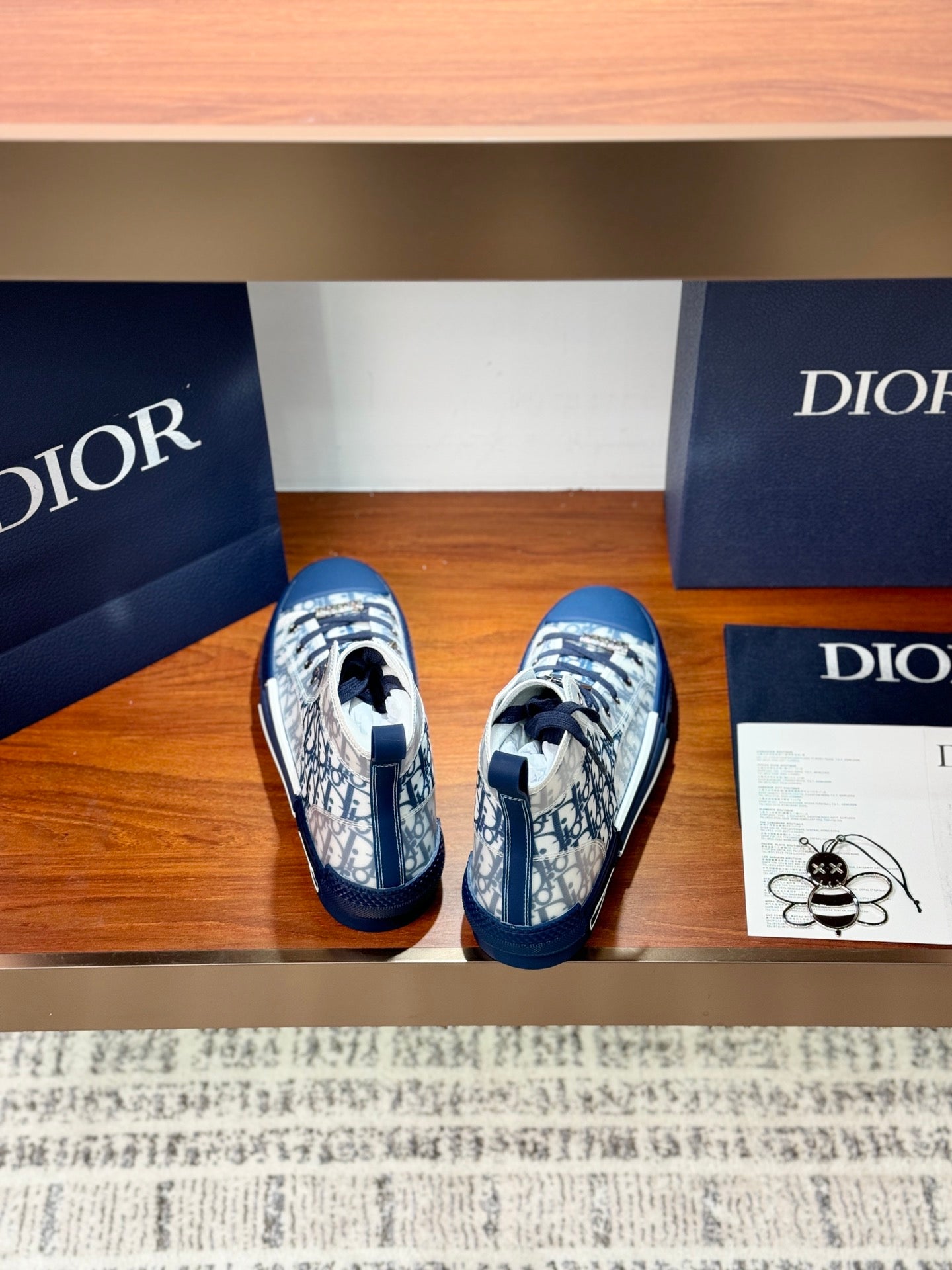 High-top sneakers with Dior monogram print and blue rubber caps, rear view