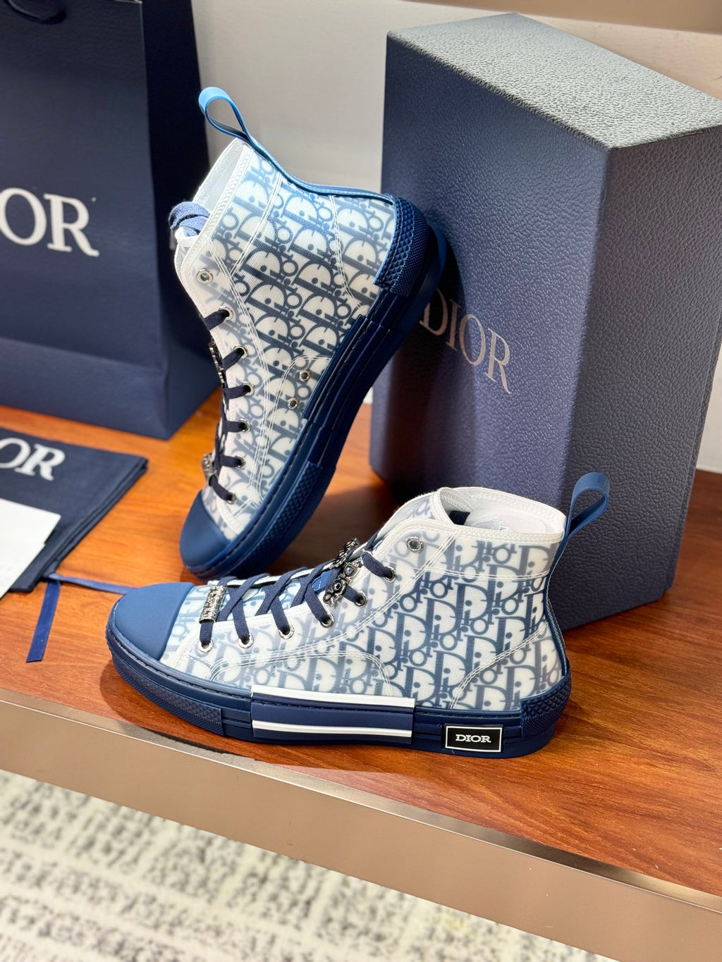 High-top sneakers with blue and white Dior monogram print, angled pair