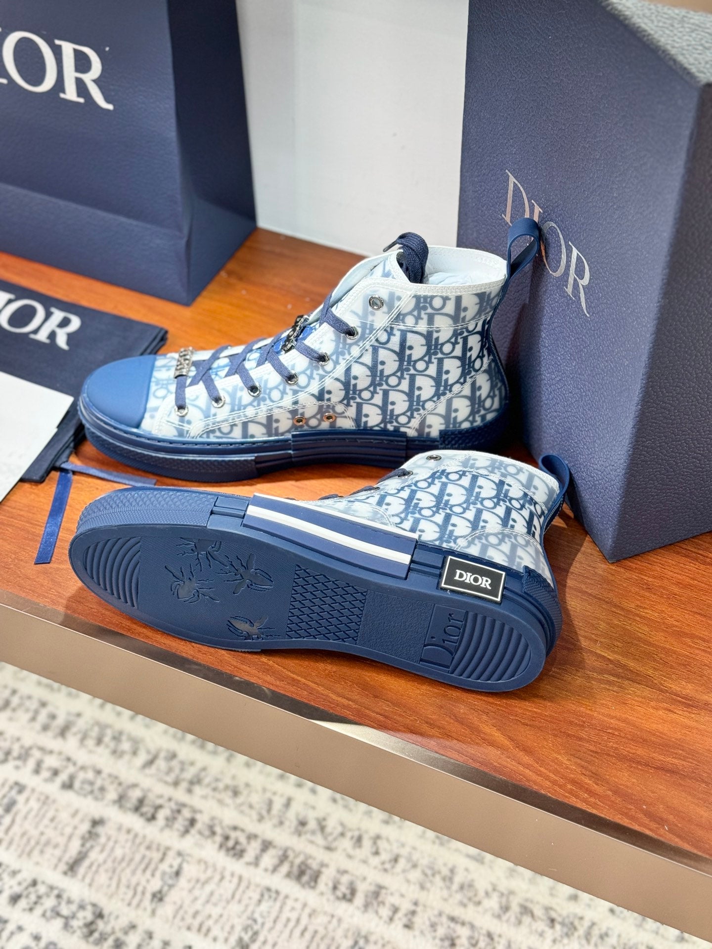 High-top sneakers with Dior monogram uppers and textured blue soles