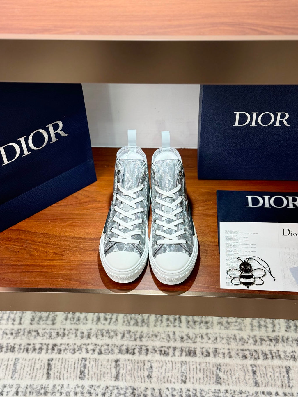 Gray Dior high-top sneakers with geometric monogram pattern and white laces