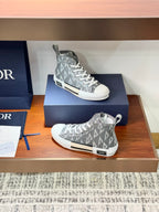 Gray Dior high-top sneakers on box, lace-up closure with monogram pattern