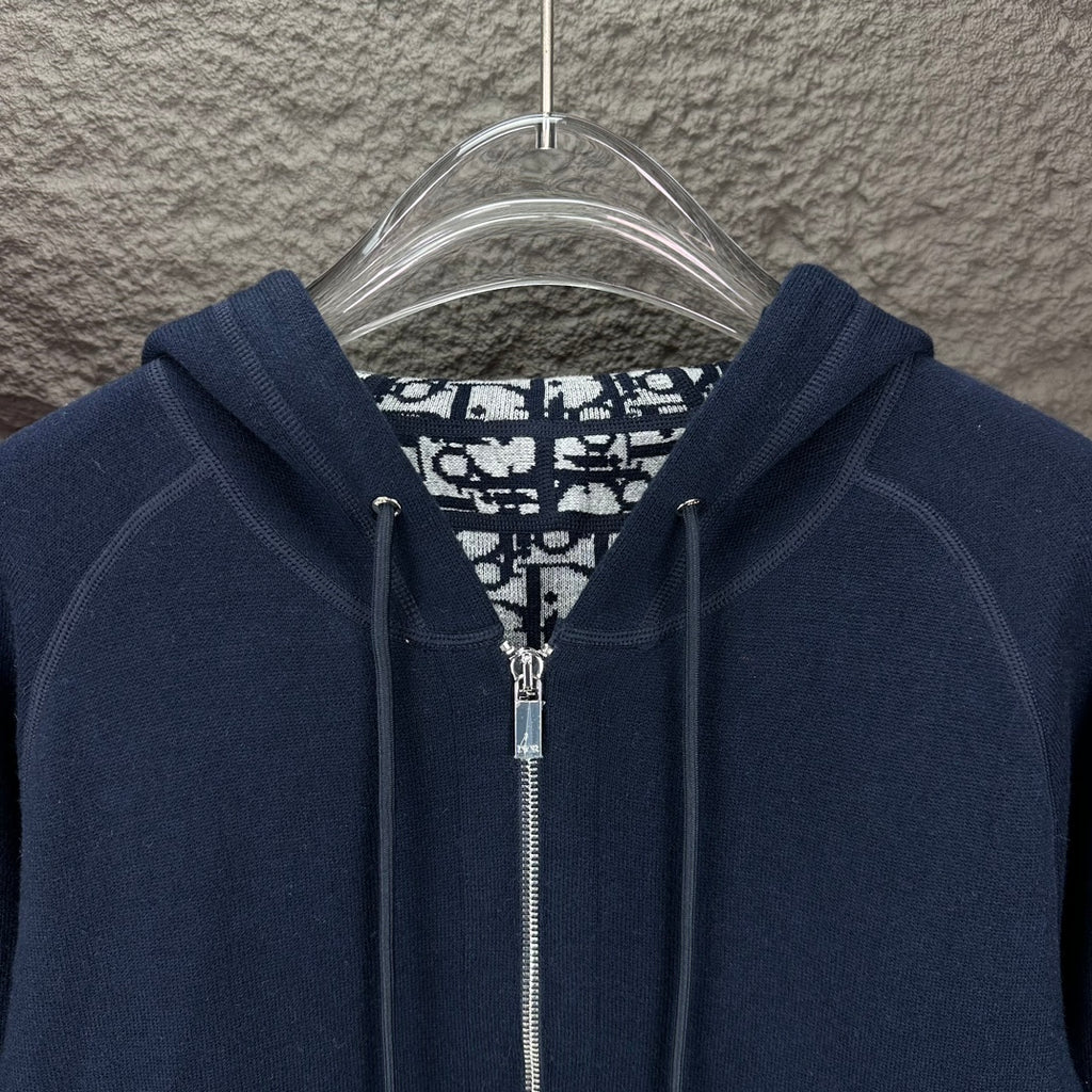 Dior long hoodie close-up: dark navy hood with metal zipper and patterned inner lining
