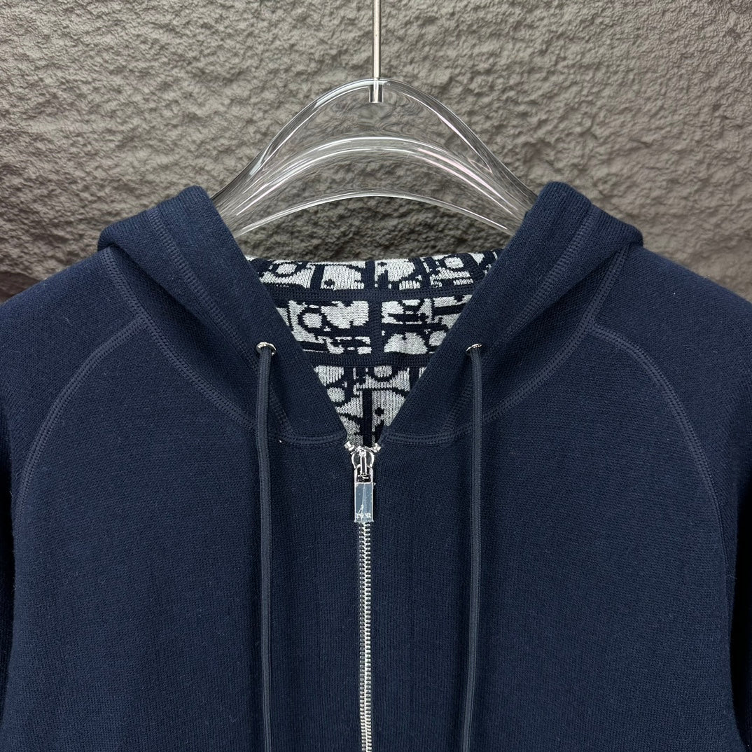 Dior long hoodie close-up: dark navy hood with metal zipper and patterned inner lining