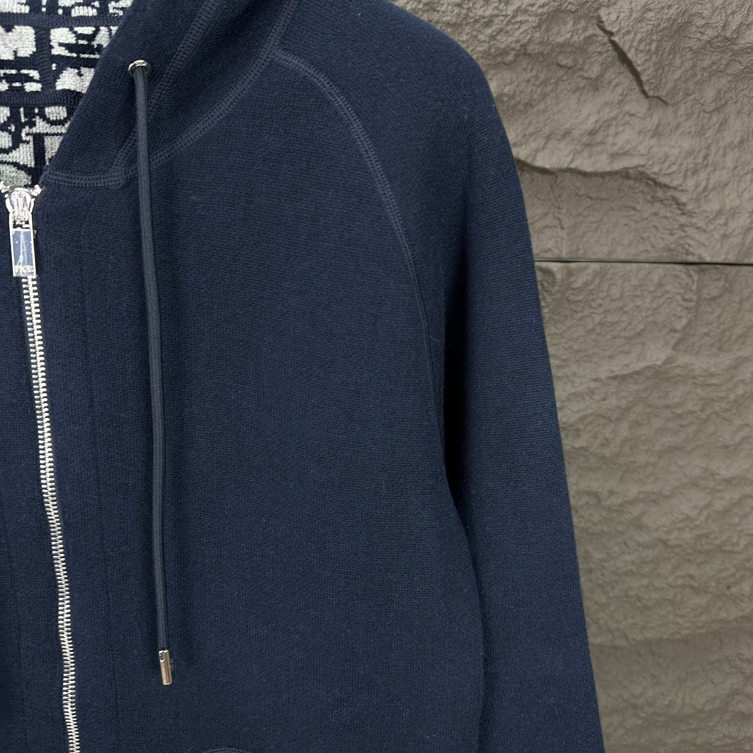 Dior long hoodie sleeve and shoulder close-up with dark navy zip front detail