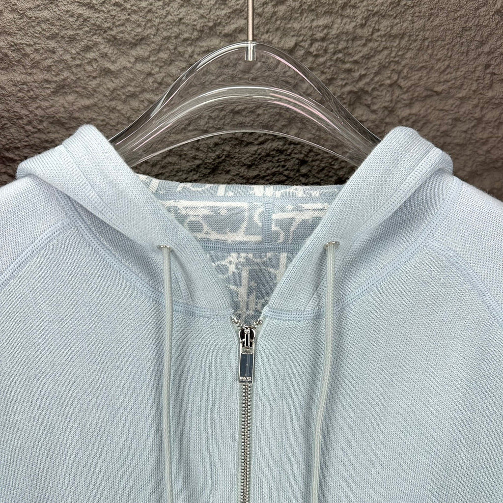 Light blue Dior zip-up hoodie close-up of hood lining and zipper pull