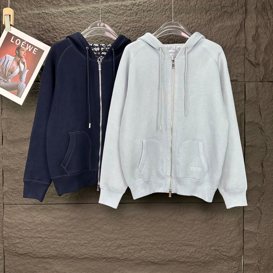 Pair of Dior zip-up hoodies on hangers: light blue and dark blue