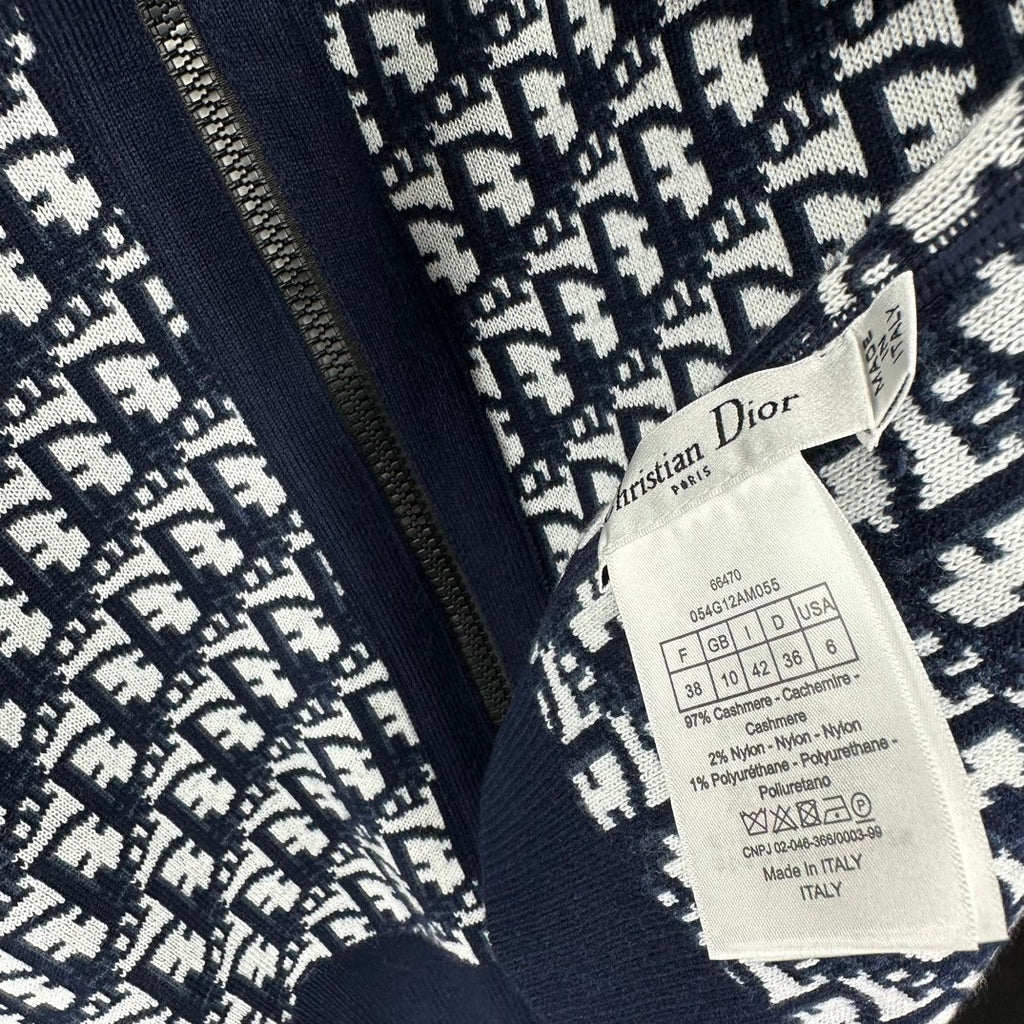 Navy monogram knit hoodie close-up with hanging Dior label tag