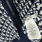 Navy monogram knit hoodie close-up with hanging Dior label tag
