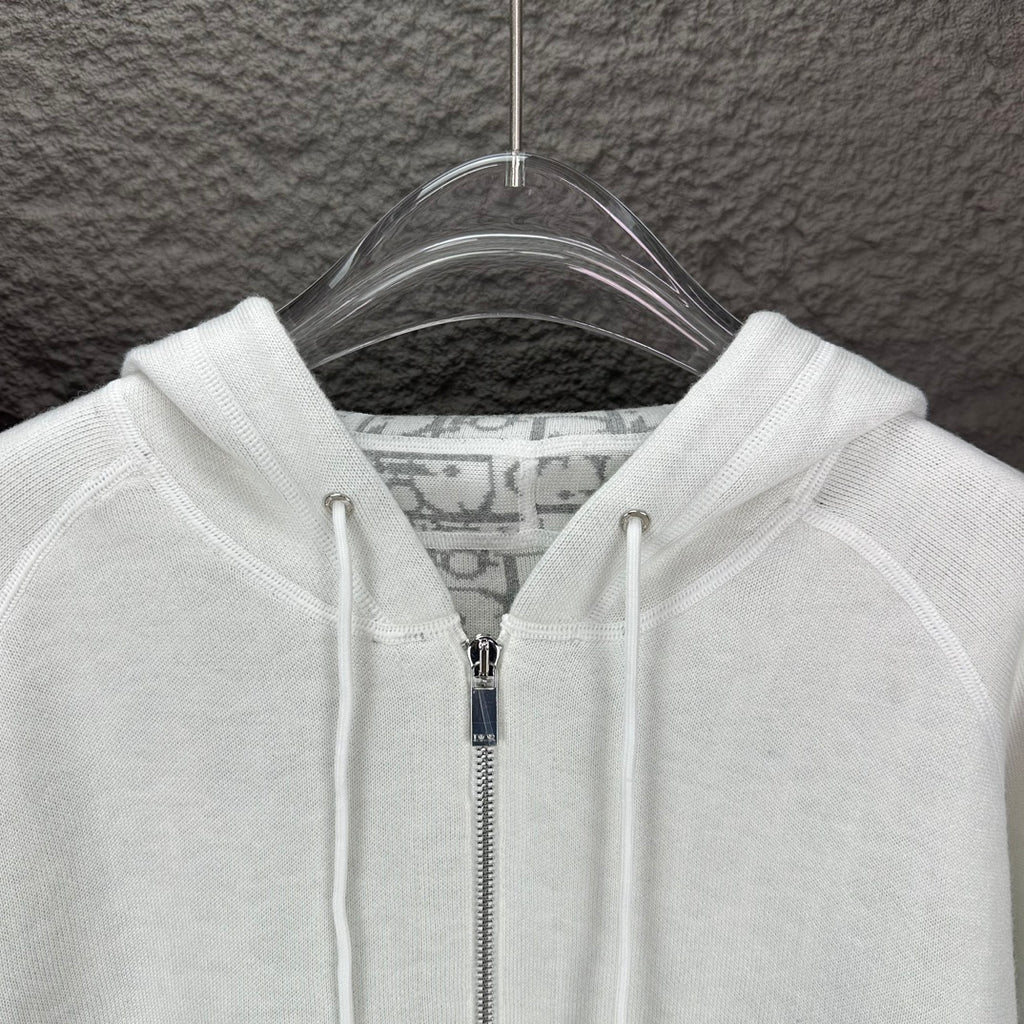 Dior white hood and front zipper close-up with drawcord tips