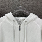 Dior white hood and front zipper close-up with drawcord tips