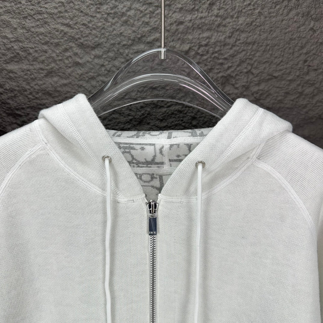 Dior white hood and front zipper close-up with drawcord tips
